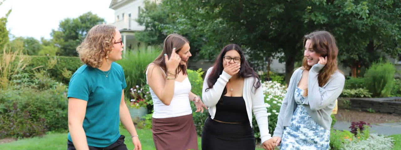 Four Precollege students laughing together.