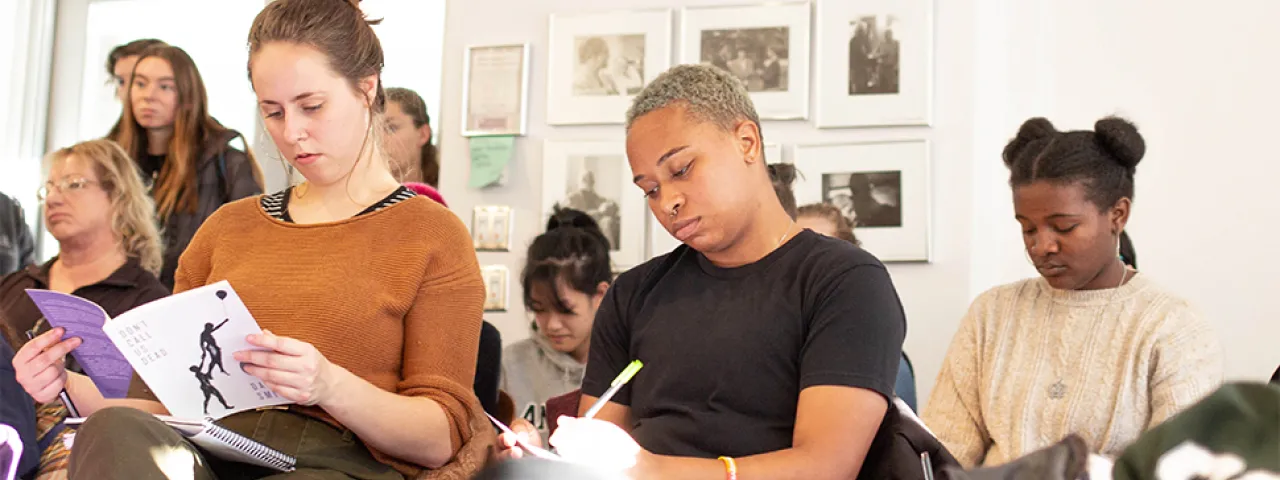 A group of students studying poetry