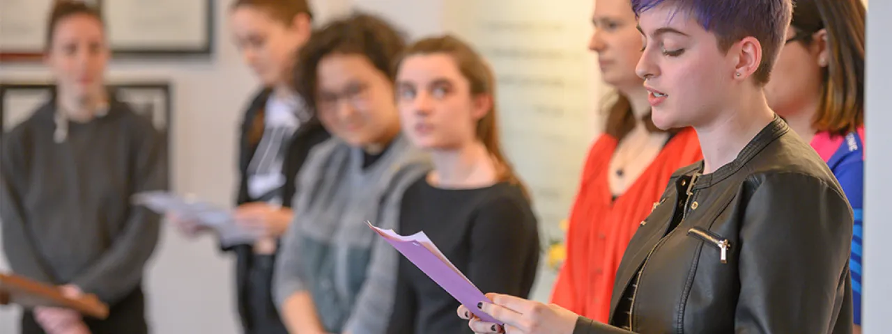 Banner image of student reciting poetry