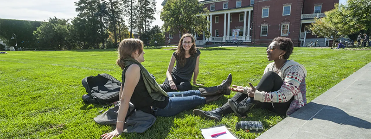 A group of students sitting on the lawn