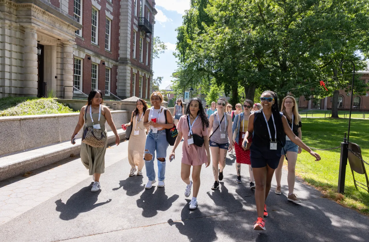 A group of alums walking in front of Seelye Hall