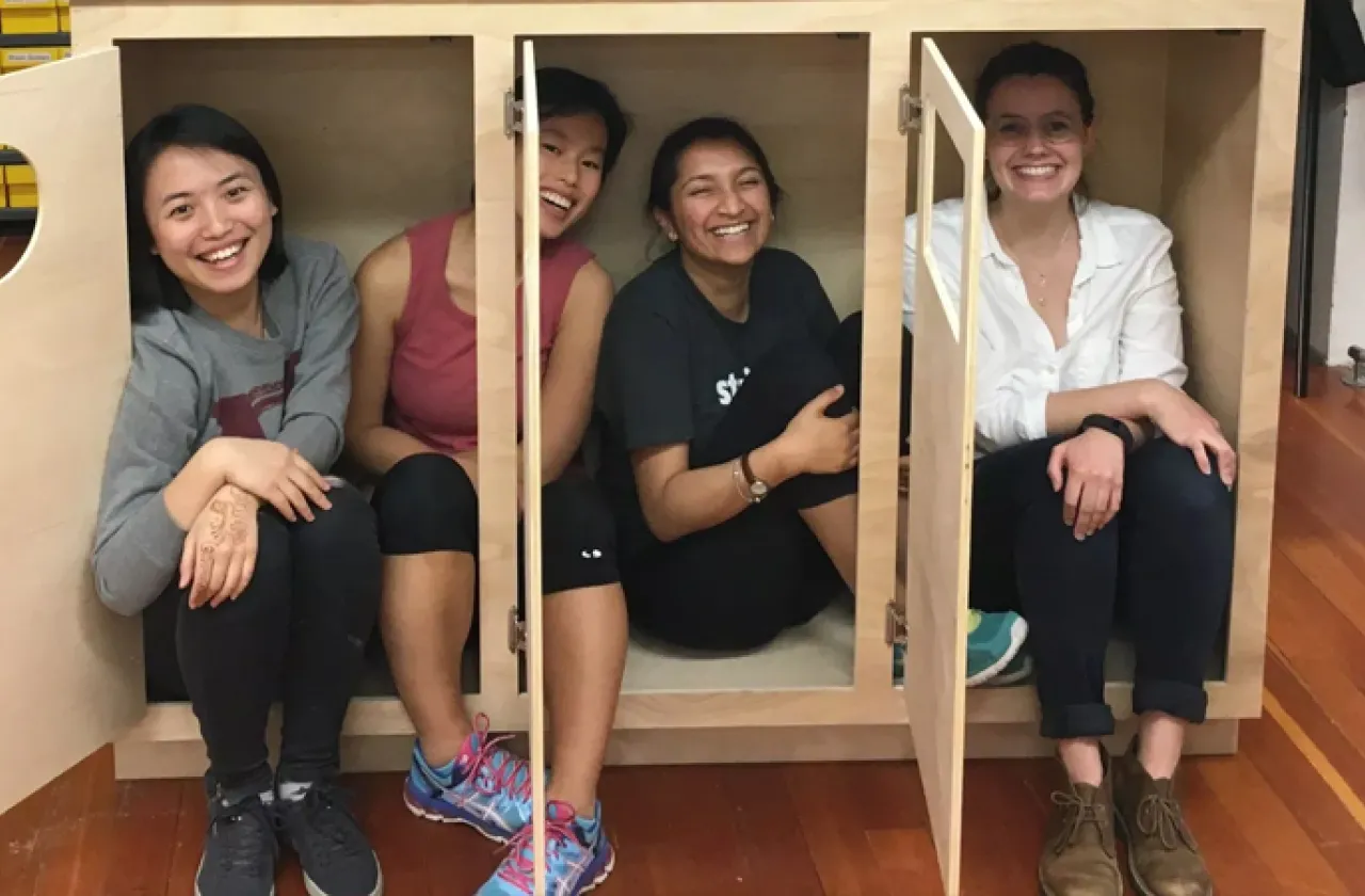 Four students smiling in the studio