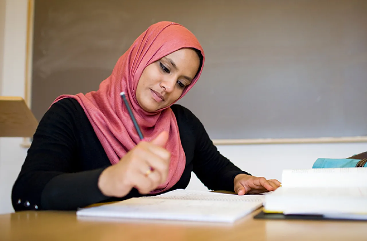 Young woman writing at a desk