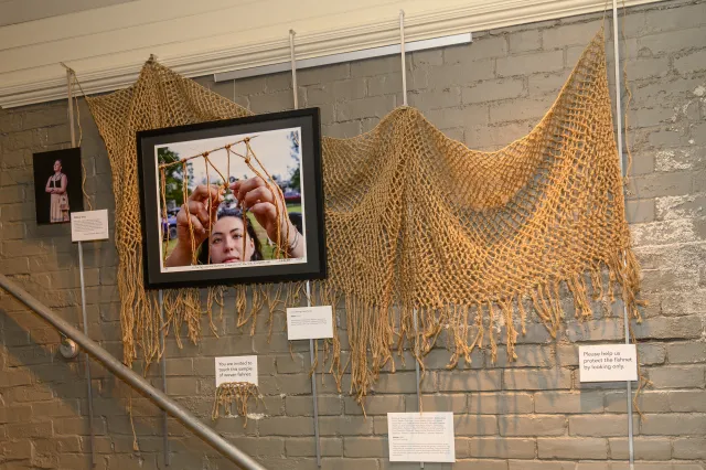 gallery with photo of woman weaving a net and the net behind it