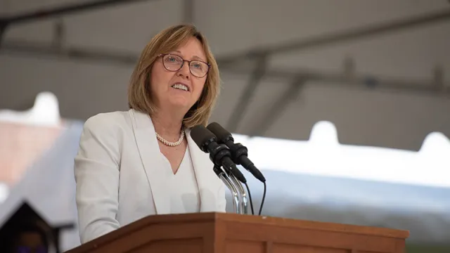 Kathleen McCartney at the podium delivering a speech