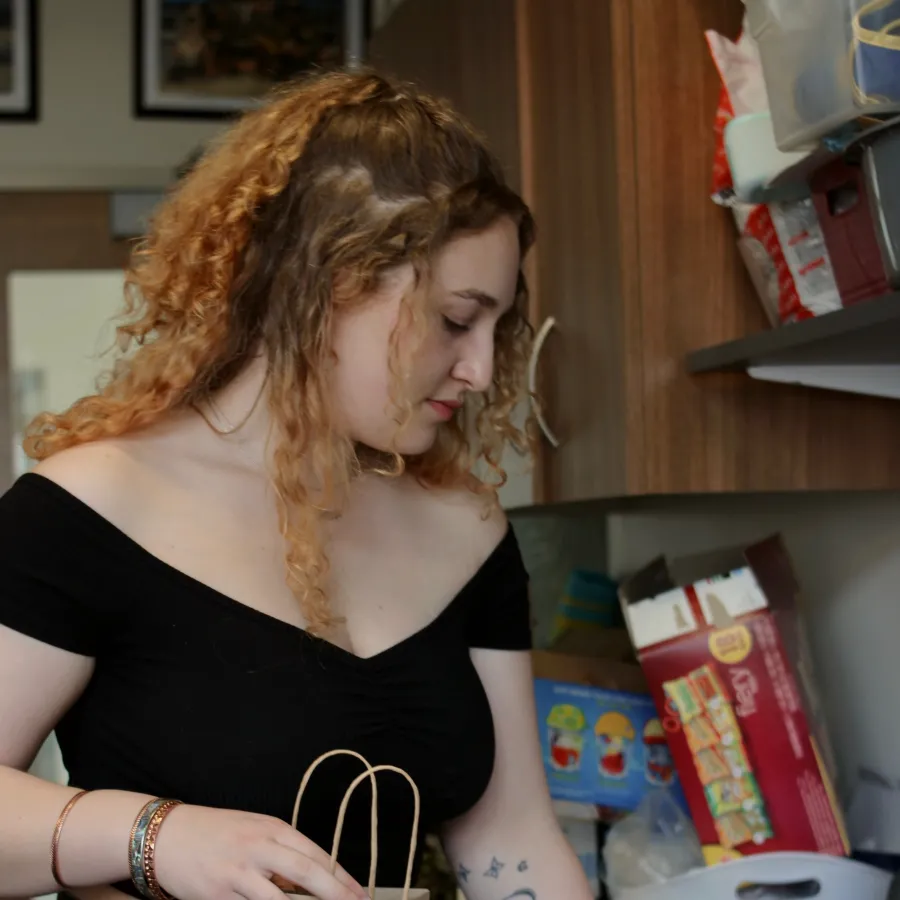 Cailin Young prepares a harm reduction bag in the Schacht Center