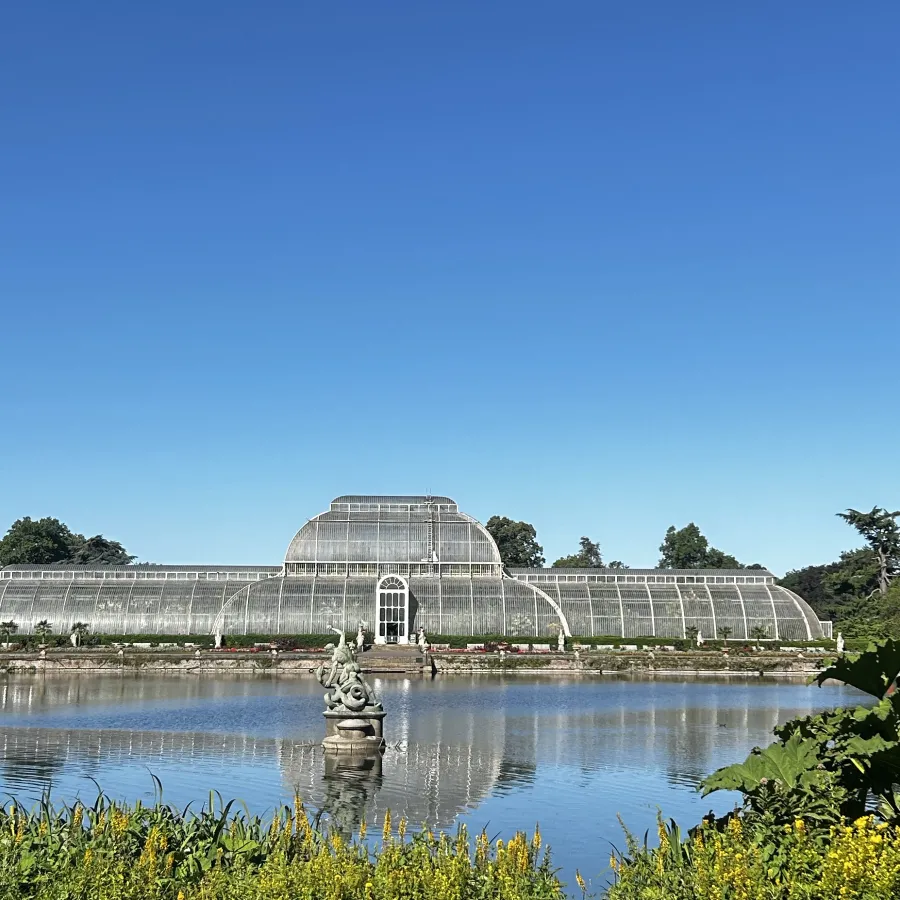 glass conservatory in front of pond.