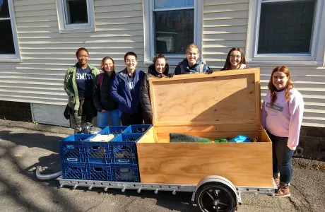 Students pose with their portable ParKit packed up on a trailer