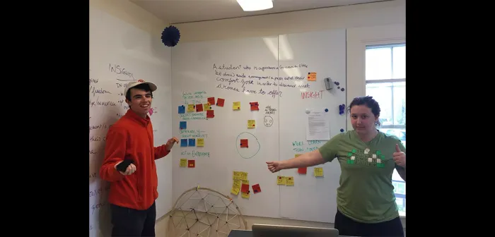 Students standing in front of a white board