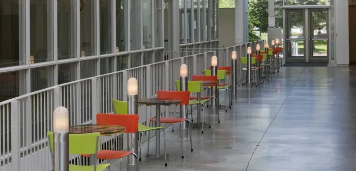 Small tables line a railing, Campus Center, Smith College