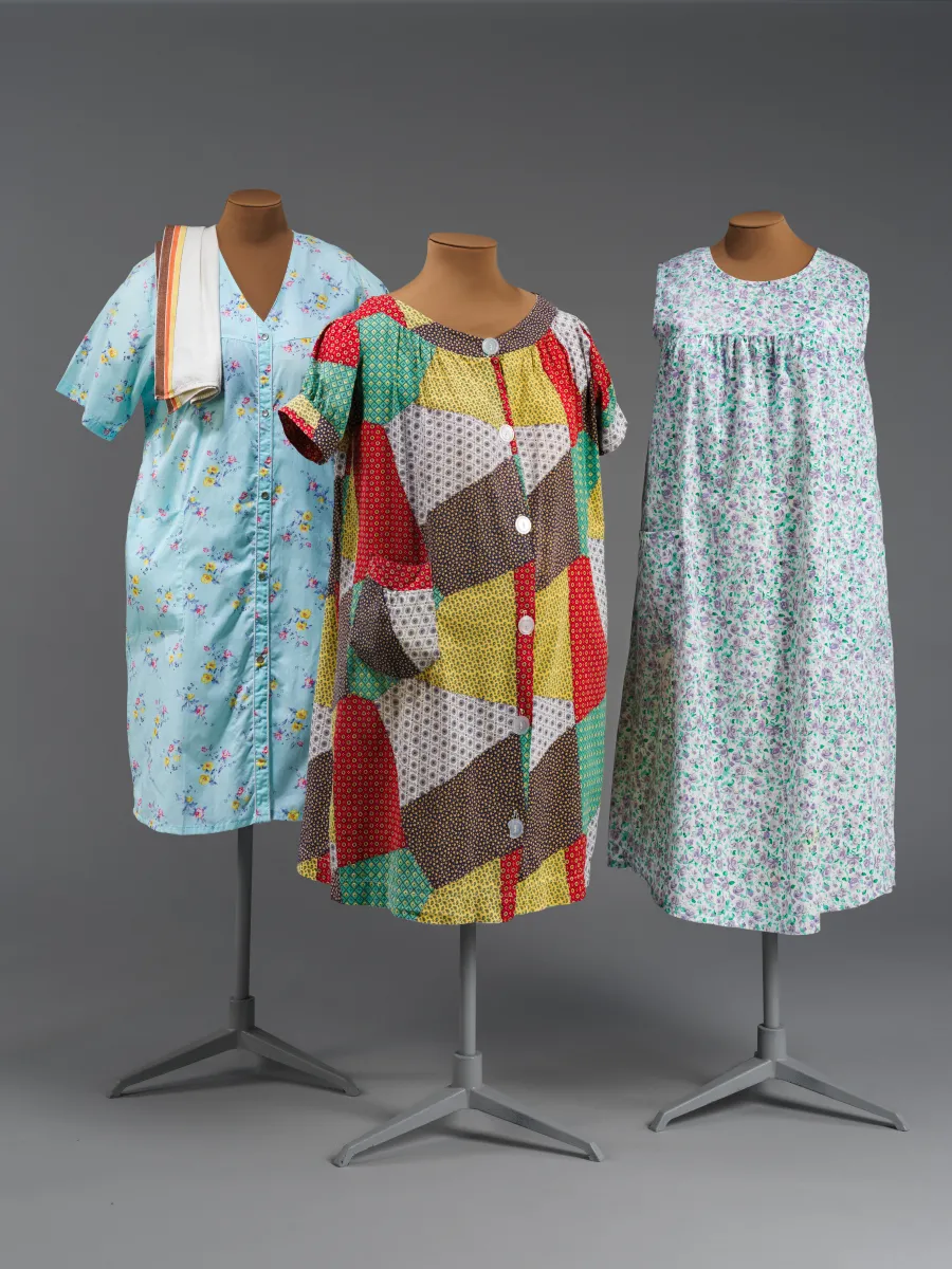 Three knee-length housecoats on mannequins with various patterns and colors.