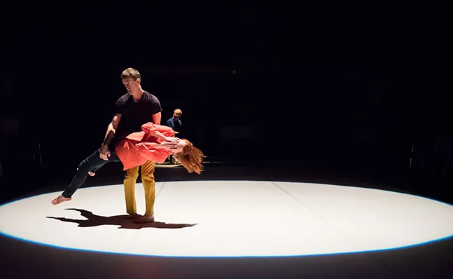 Two dancers in a spotlight