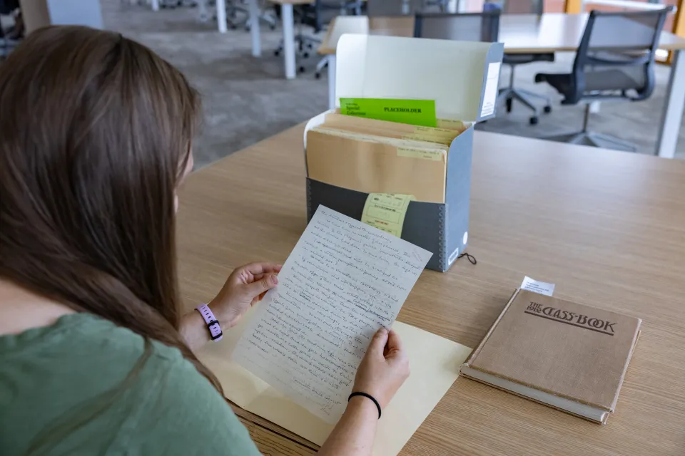 Kady Wilson reads a letter from her great-grandmother in Special Collections