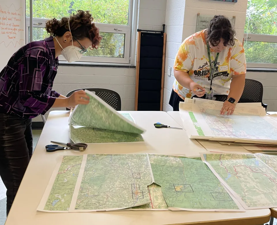 Heather Rosenfeld and a student working on maps.