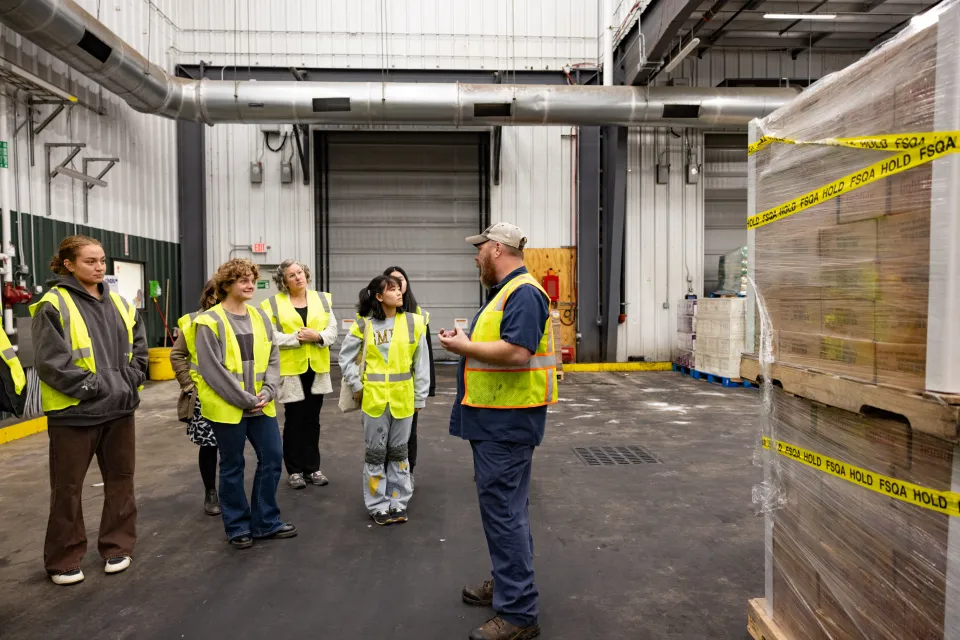 Smithies in bright yellow vests start a tour at Vanguard Renewables