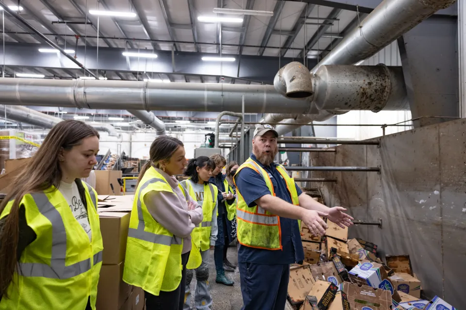 Students survey food waste going into the Vanguard machines