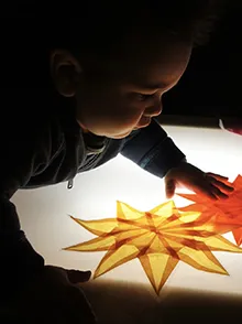 Small child arranging colored paper pieces