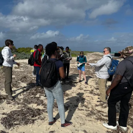 A group of high school students on the beach in Turks & Caicos with Smith geology professors and students.